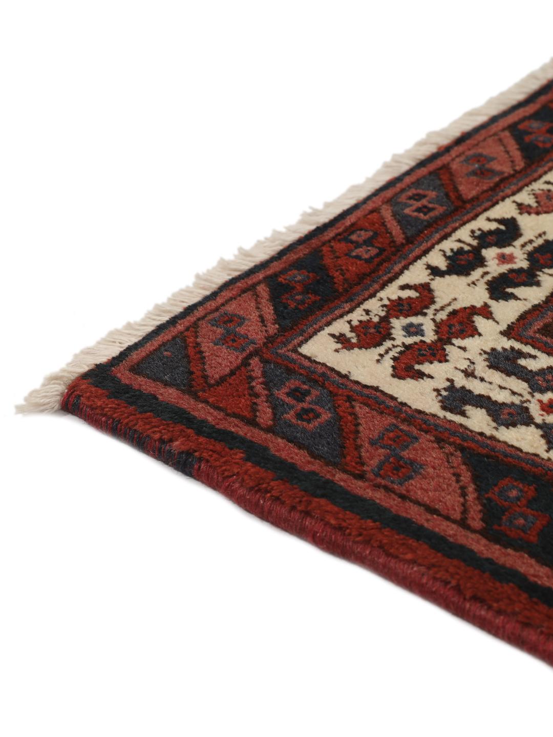A hand-knotted Afshar rug from the Middle East in deep red featuring geometric medallions.