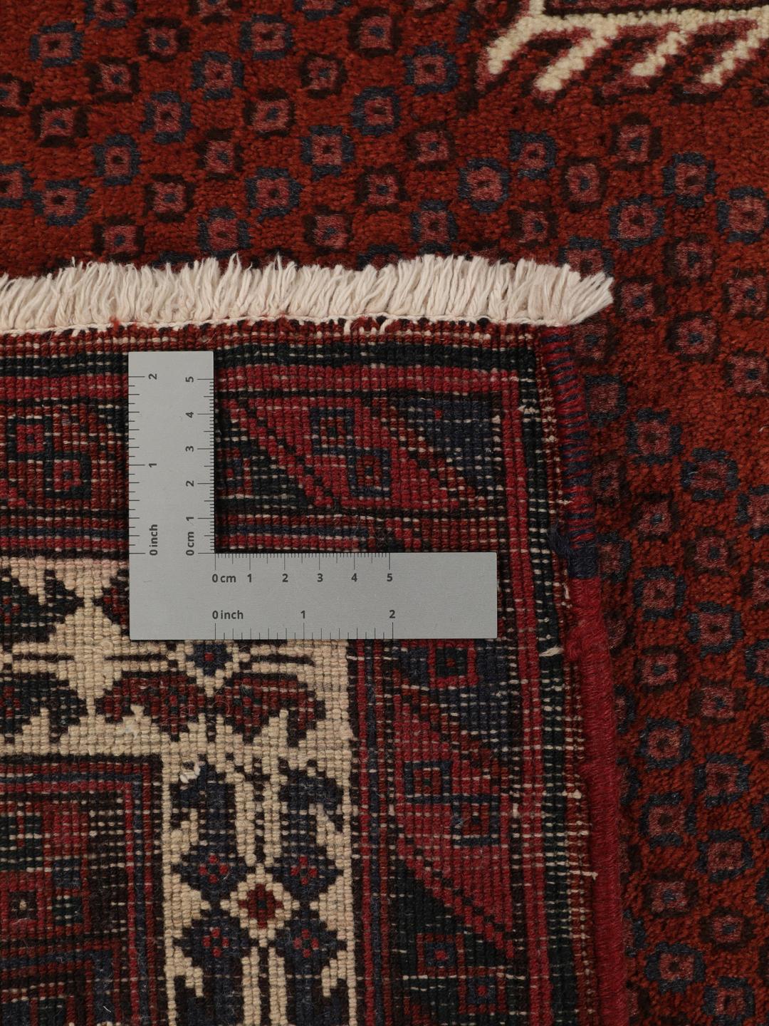 A hand-knotted Afshar rug from the Middle East in deep red featuring geometric medallions.