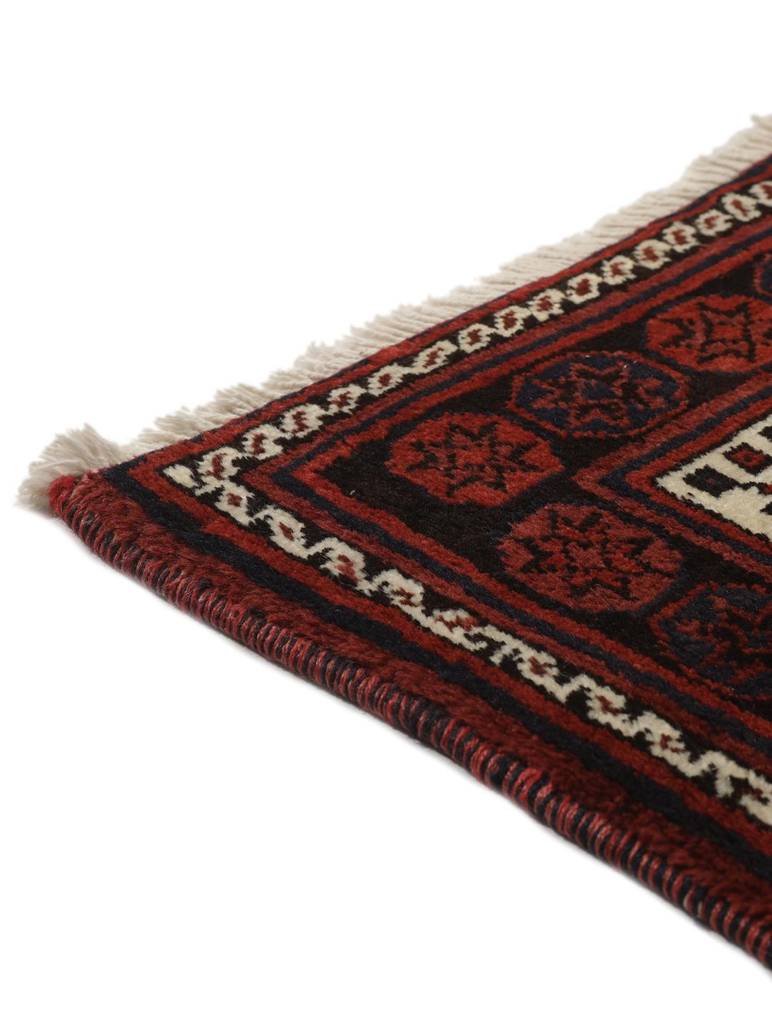 Hand knotted rug from the Middle East in dark red tones