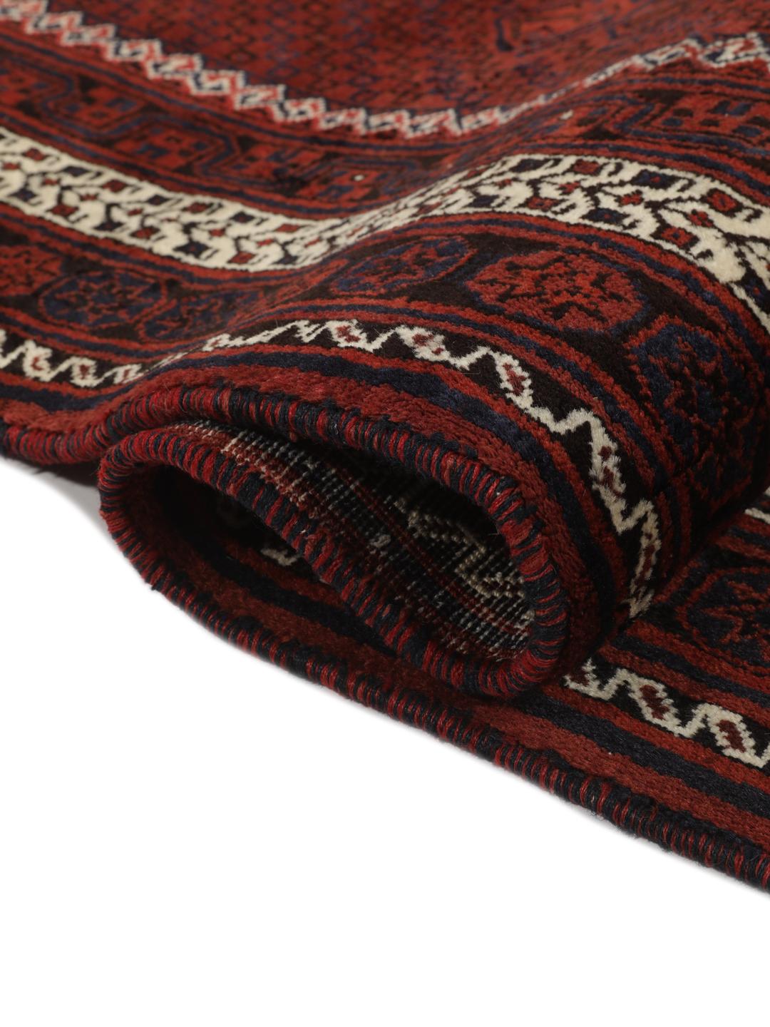Hand knotted rug from the Middle East in dark red tones