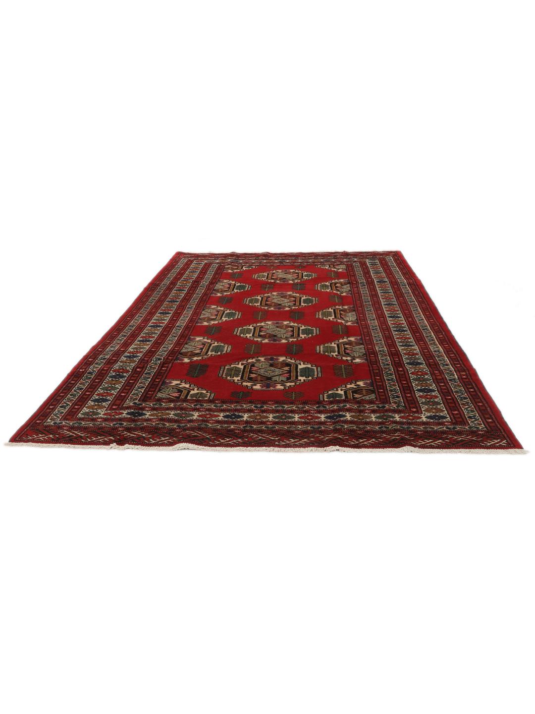 A hand-knotted Turkaman rug from the Middle East with a deep red field and traditional geometric motifs.