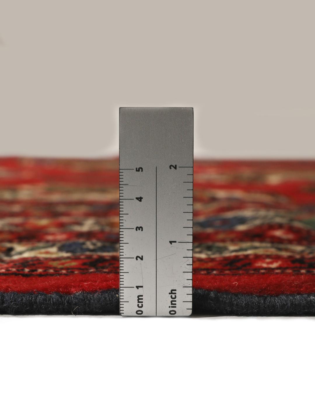 A hand-knotted Turkaman rug from the Middle East with a deep red field and traditional geometric motifs.