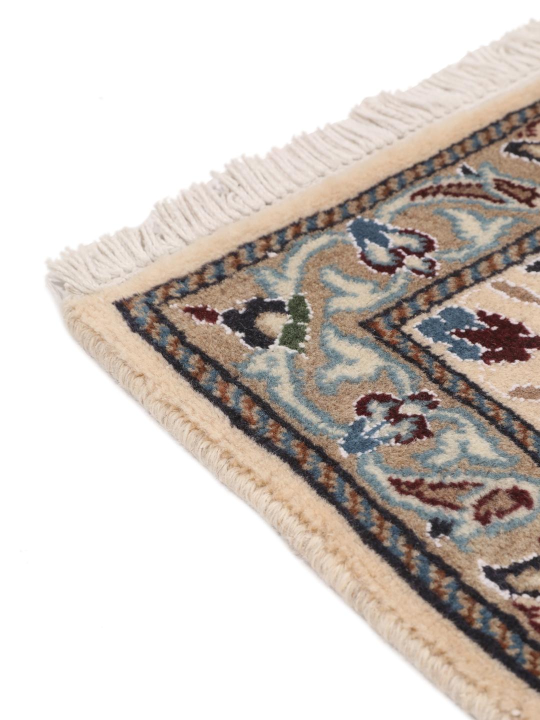 Hand-knotted Nain rug from the Middle East with a dark-blue and cream floral design.