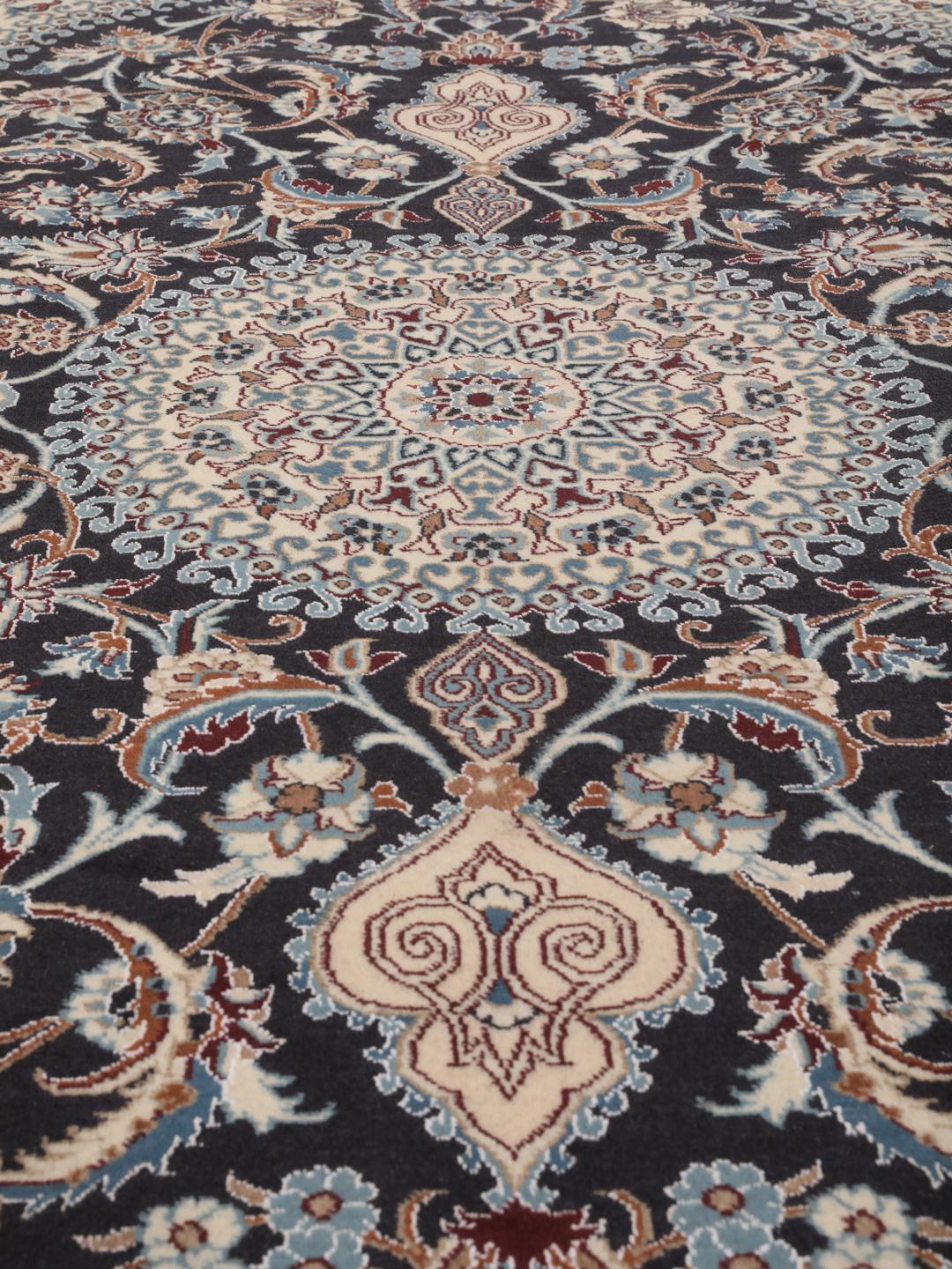 Hand-knotted Nain rug from the Middle East with a dark-blue and cream floral design.