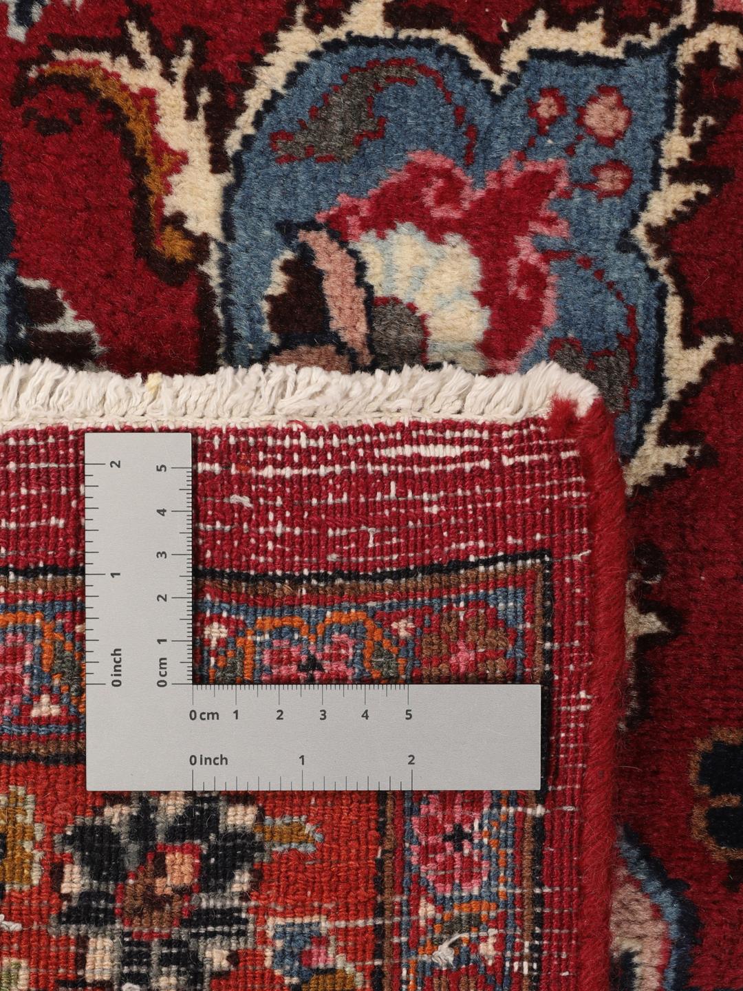 Hand-knotted Mashad rug from the Middle East in deep dark-red with floral pattern