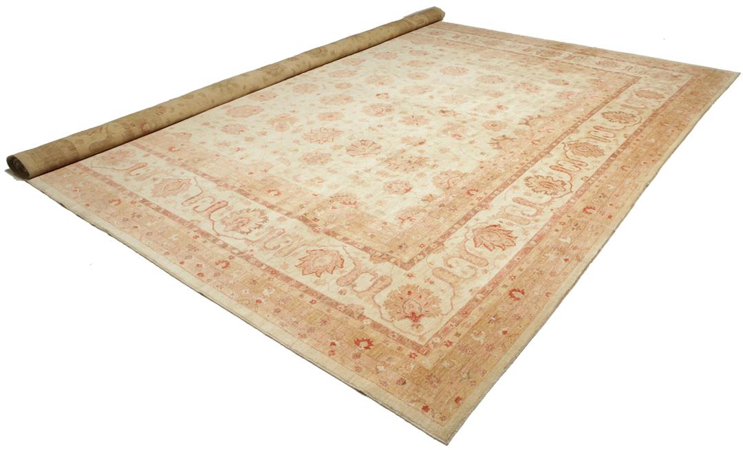 A large, hand-knotted Ziegler rug from Pakistan featuring a neutral beige and soft red floral pattern.