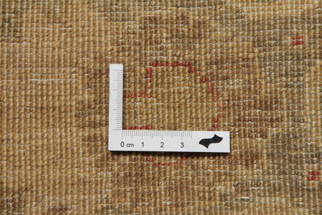 A large, hand-knotted Ziegler rug from Pakistan featuring a neutral beige and soft red floral pattern.