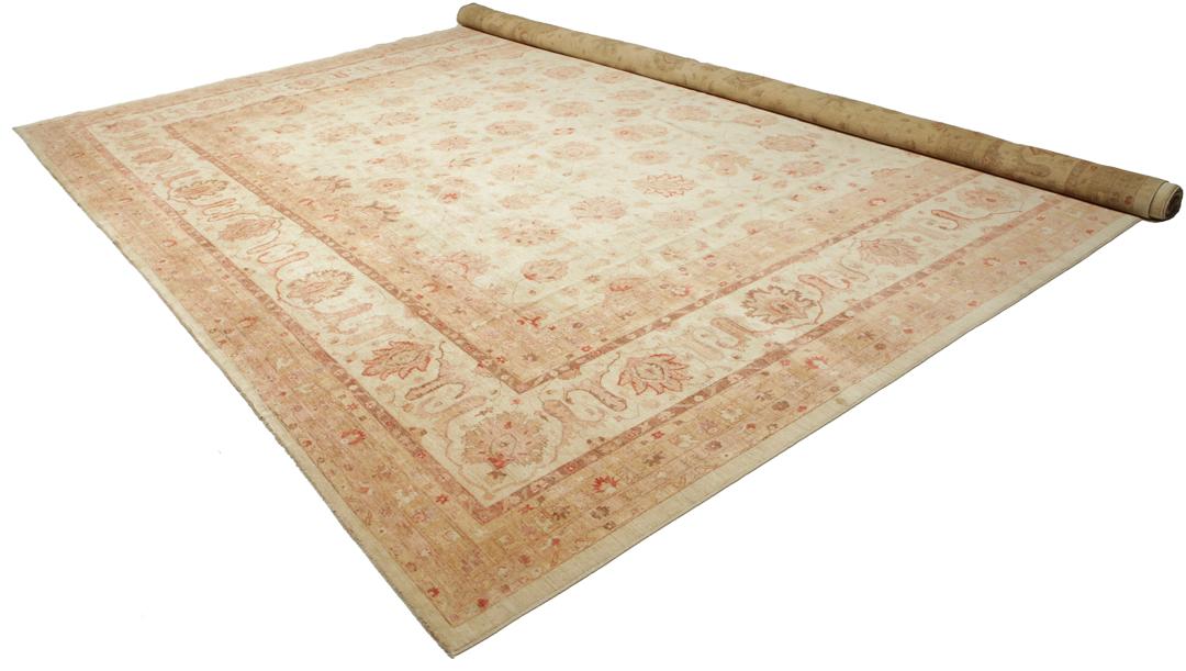 A large, hand-knotted Ziegler rug from Pakistan featuring a neutral beige and soft red floral pattern.