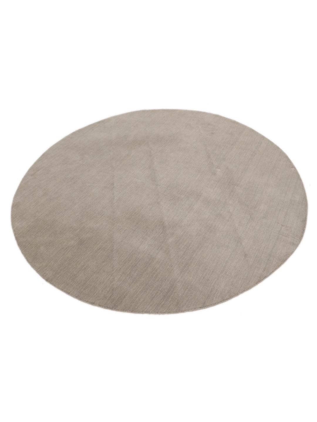 Rond beige tapijt met een minimalistische textuur