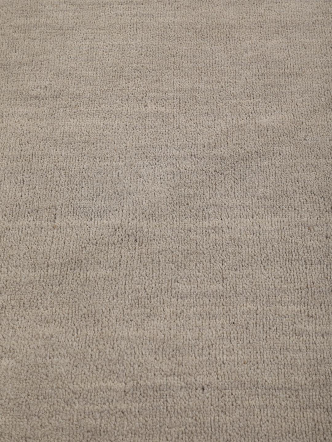 Rond beige tapijt met een minimalistische textuur