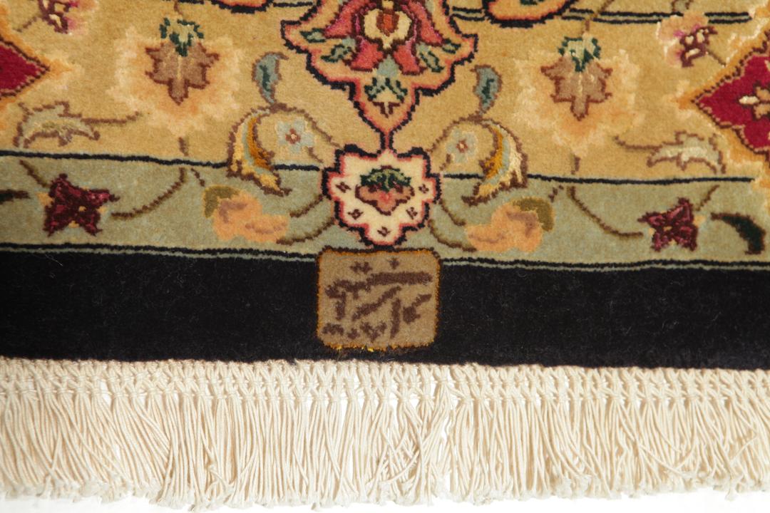 Hand-knotted Tabriz rug from the Middle East featuring a vibrant red field and intricate floral patterns.