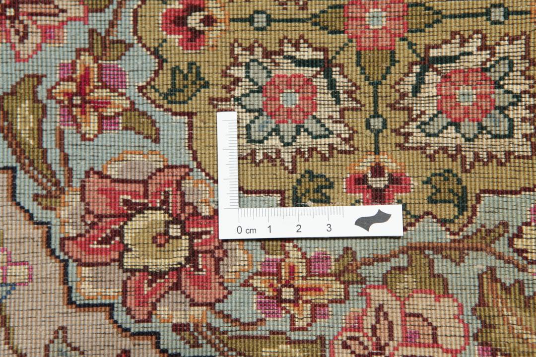 Hand-knotted Tabriz rug from the Middle East featuring a vibrant red field and intricate floral patterns.