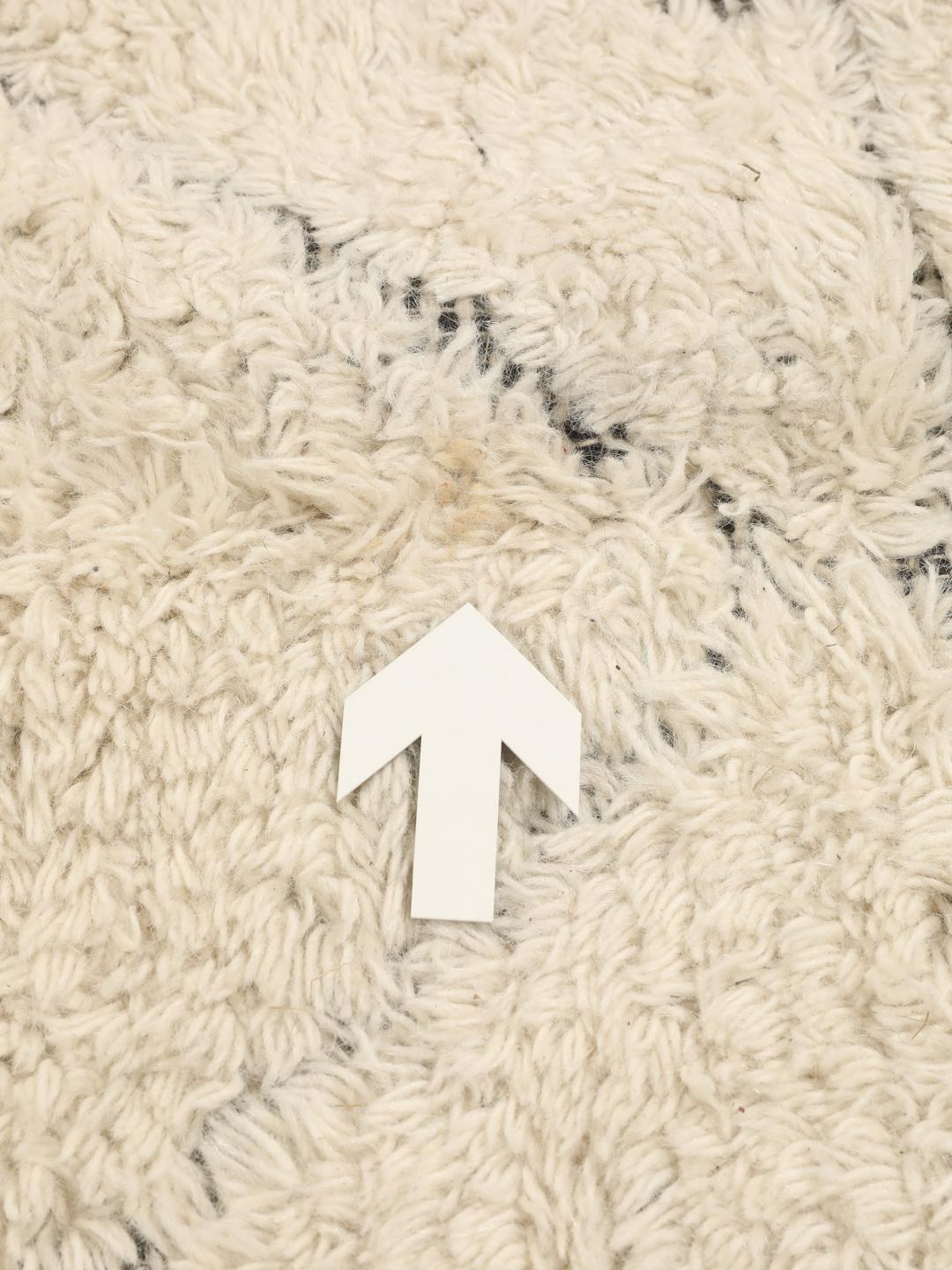 Beige vloerkleed met ruitpatronen en franjes