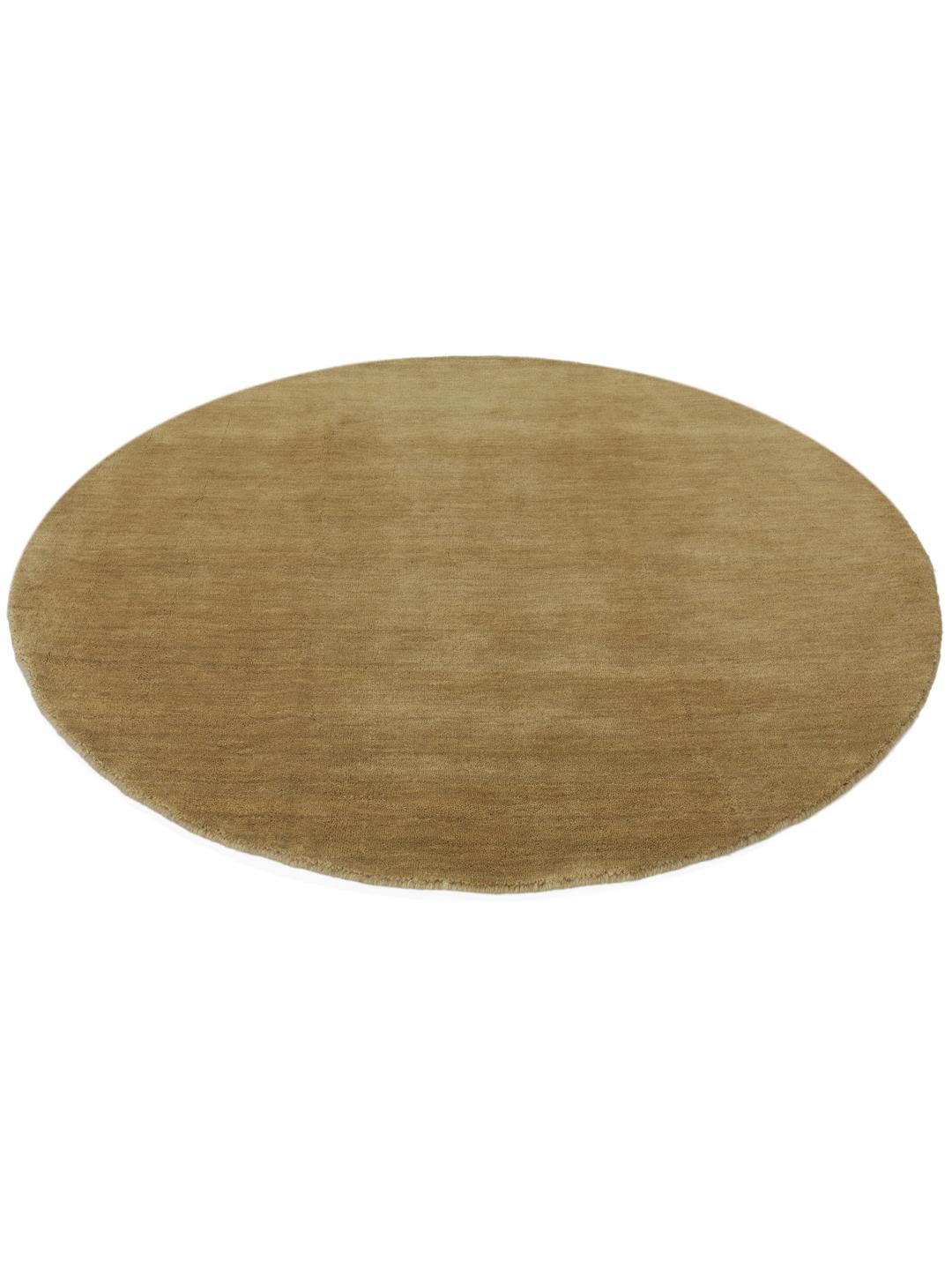 A round beige handloom rug with a soft wool pile