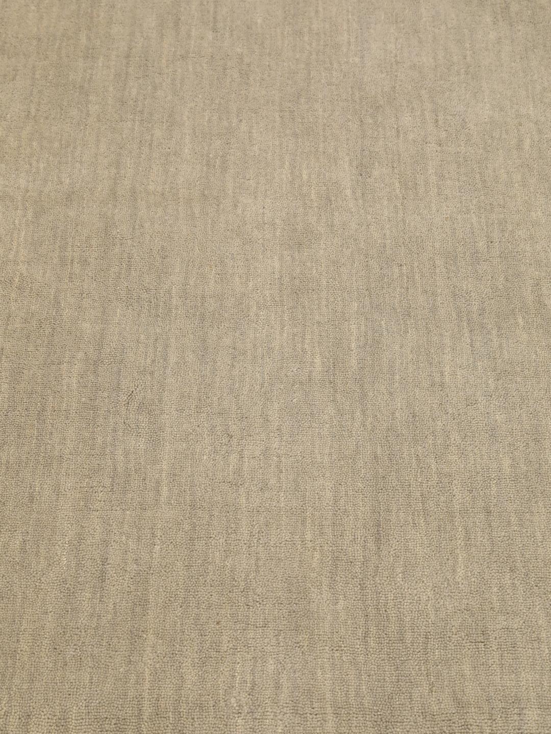 Rond beige handgeweven tapijt met een zachte textuur van wol