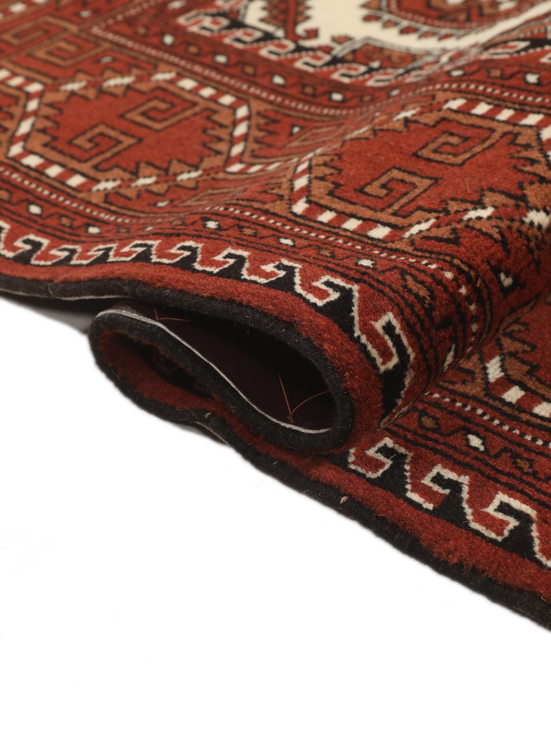 Hand-knotted Turkaman rug from the Middle East in red and cream tones