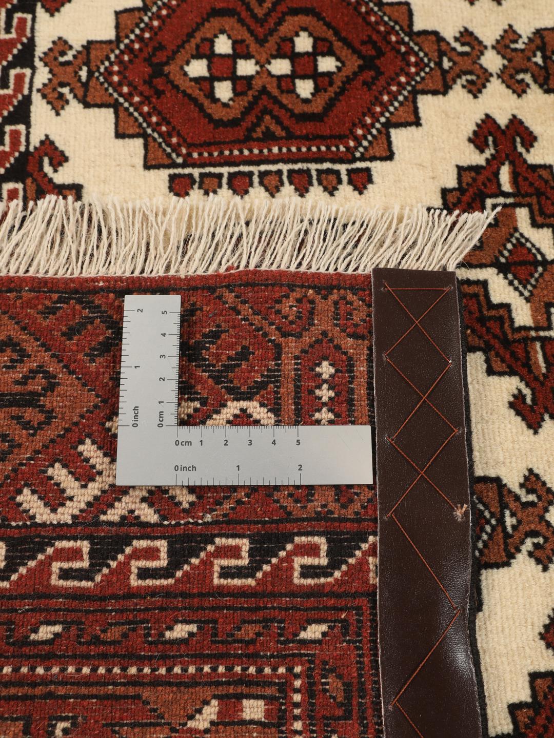 Hand-knotted Turkaman rug from the Middle East in red and cream tones
