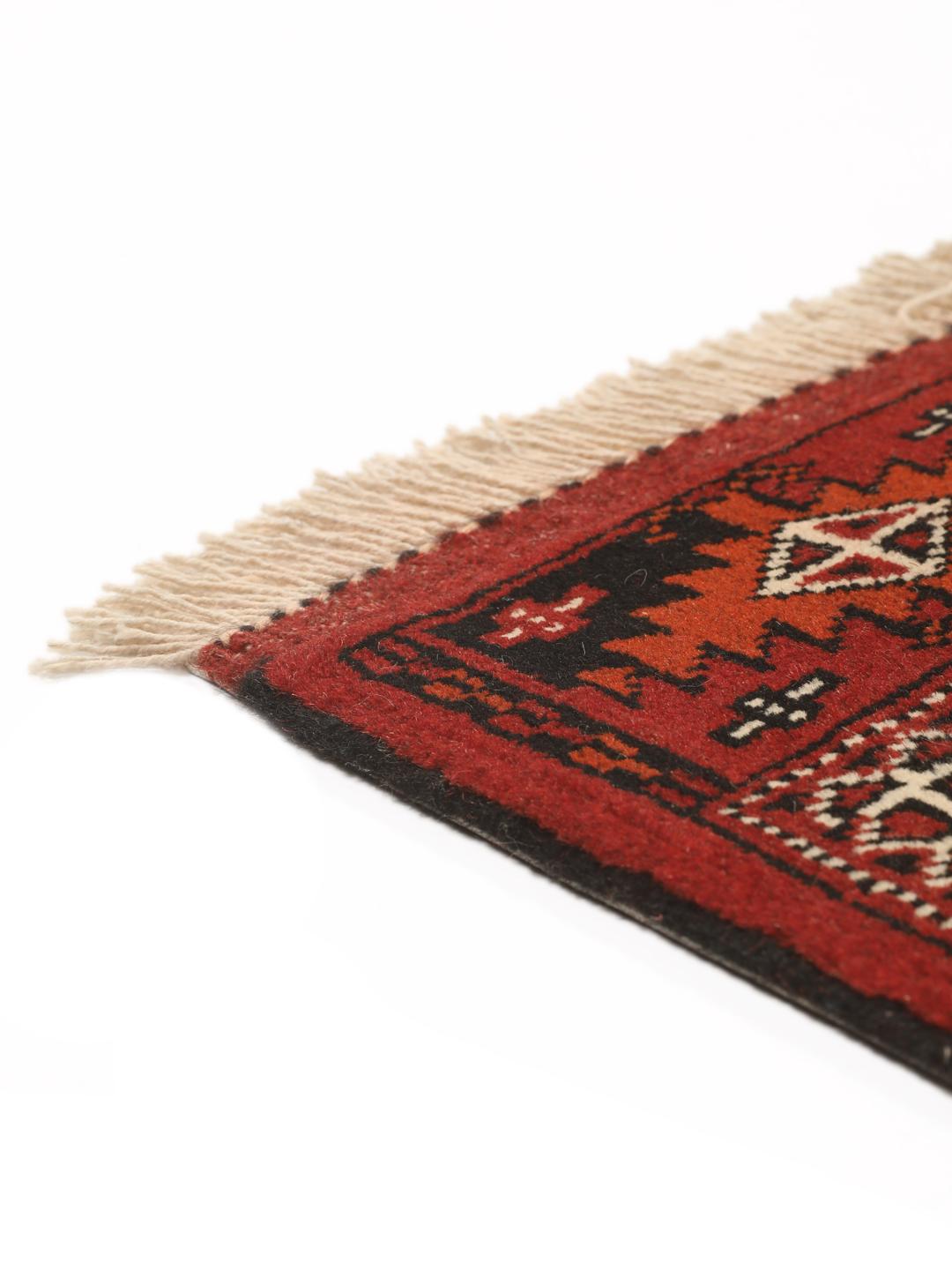 Hand-knotted Turkaman rug from the Middle East in red and black