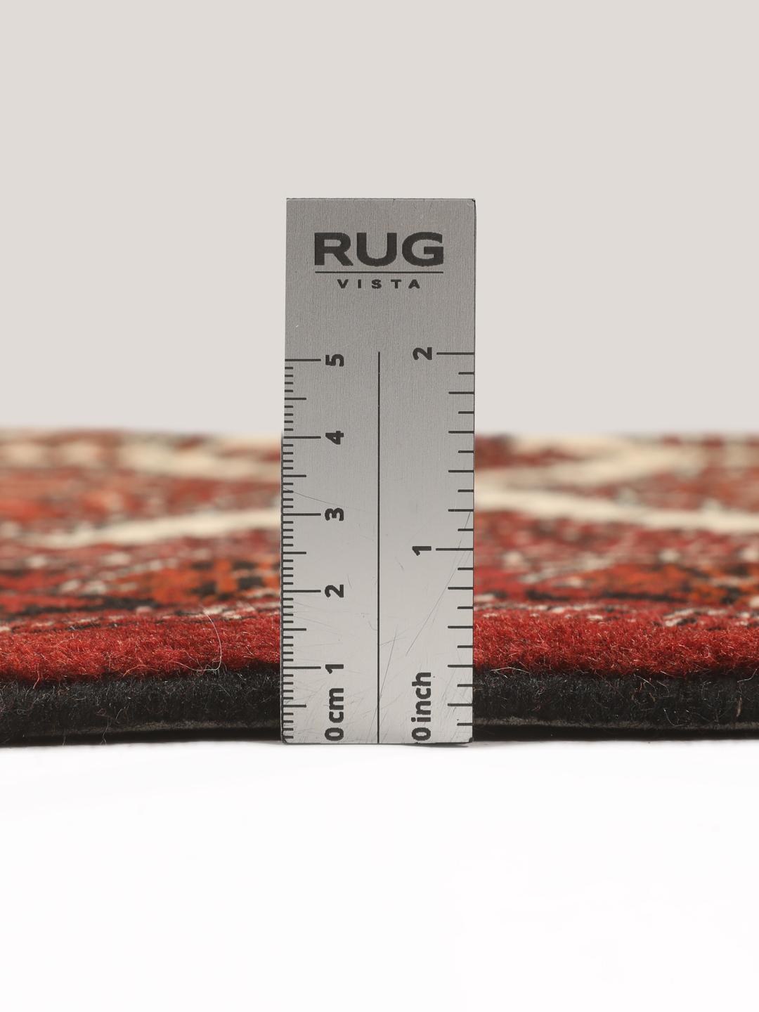 Hand-knotted Turkaman rug from the Middle East in red and black