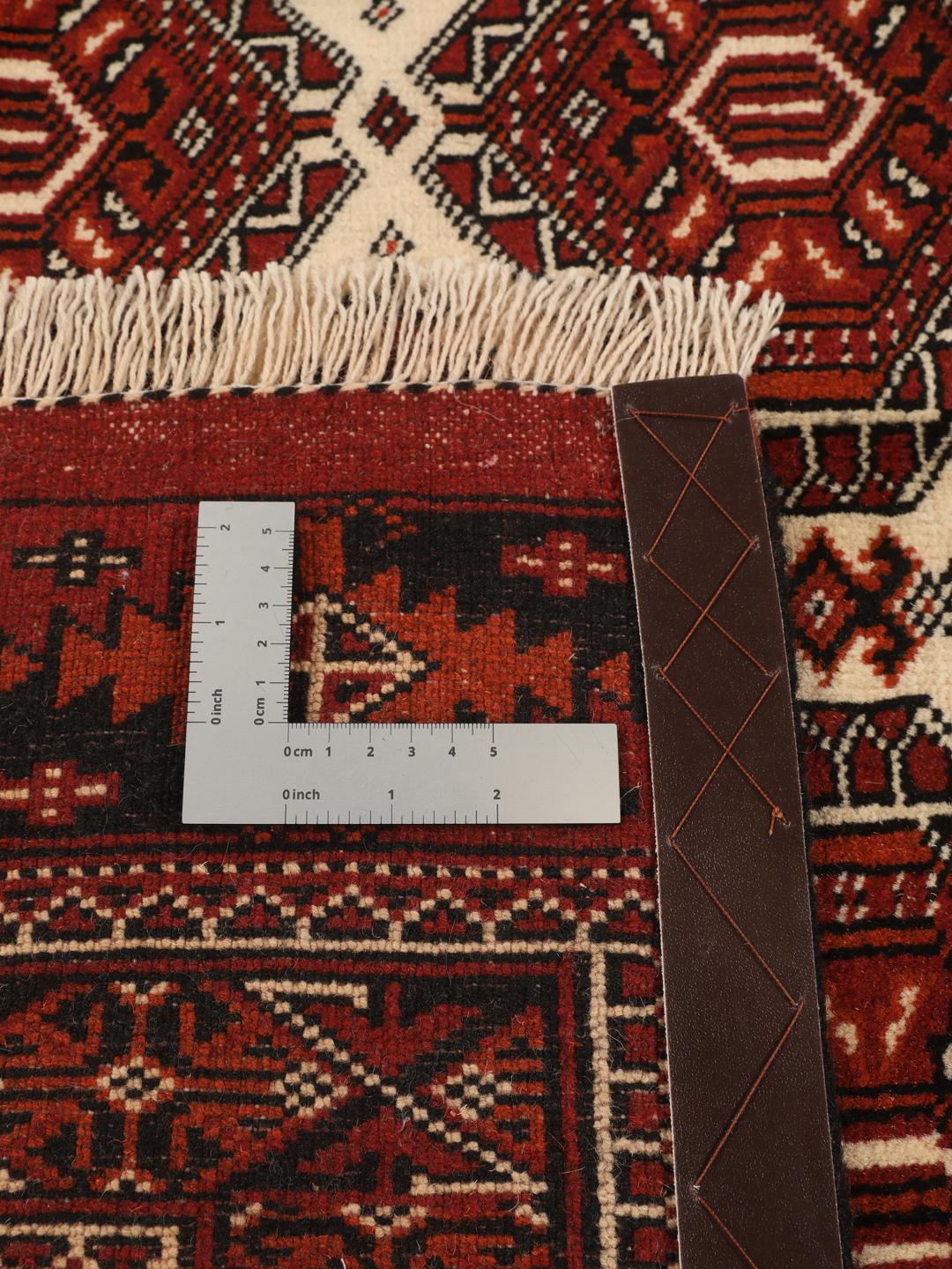 Hand-knotted Turkaman rug from the Middle East in red and black