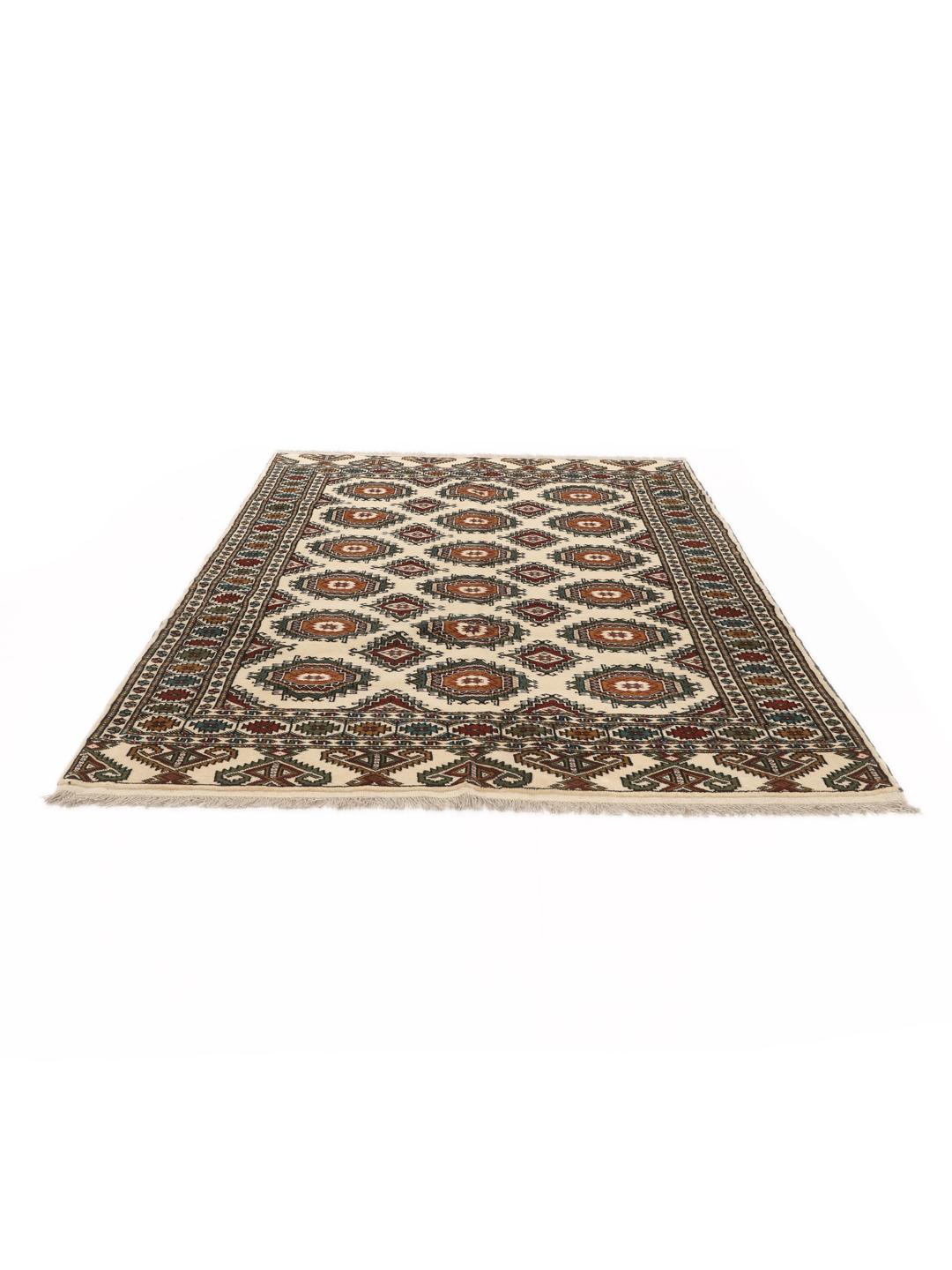 Hand-knotted Turkaman rug from the Middle East in red and beige tones.