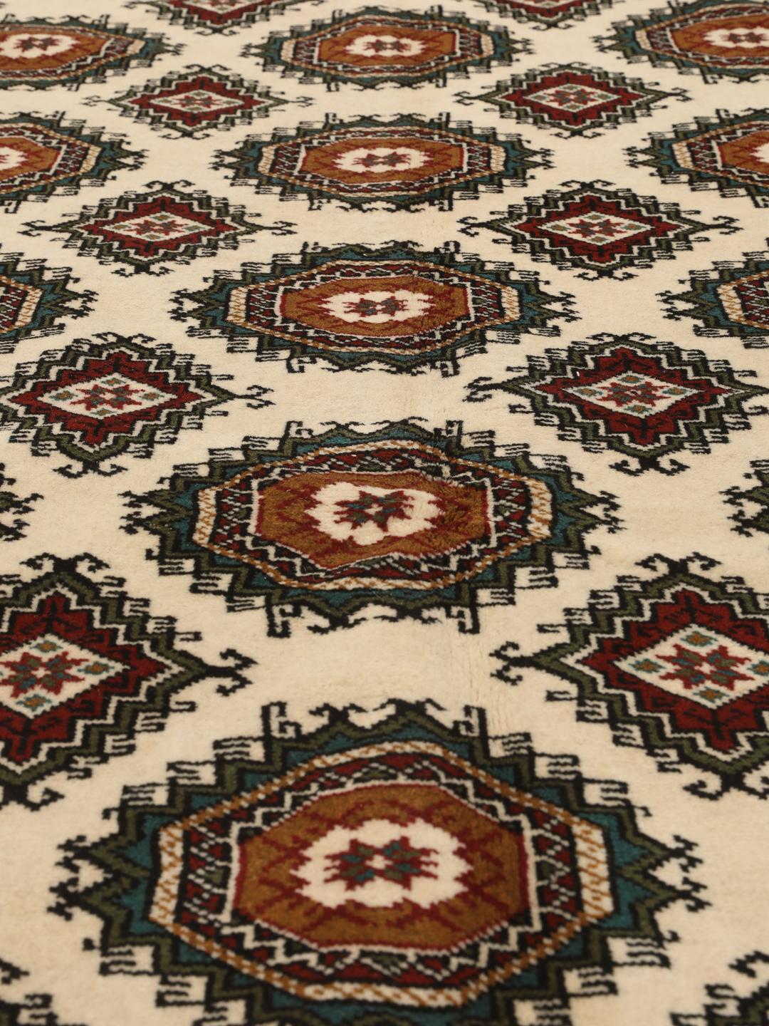 Hand-knotted Turkaman rug from the Middle East in red and beige tones.