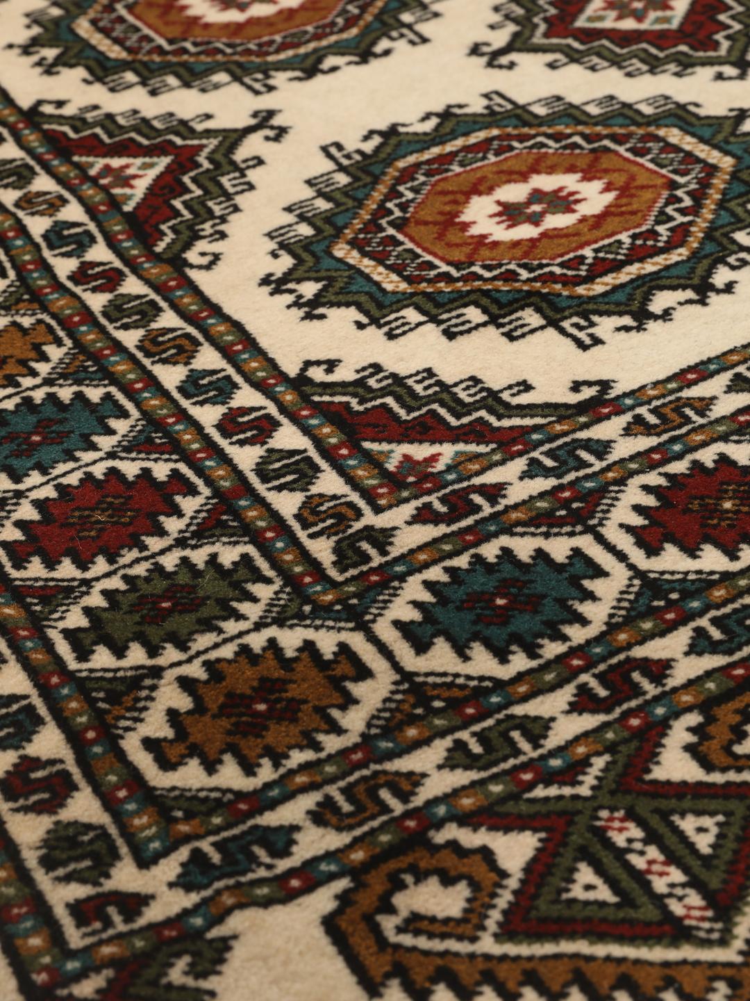 Hand-knotted Turkaman rug from the Middle East in red and beige tones.