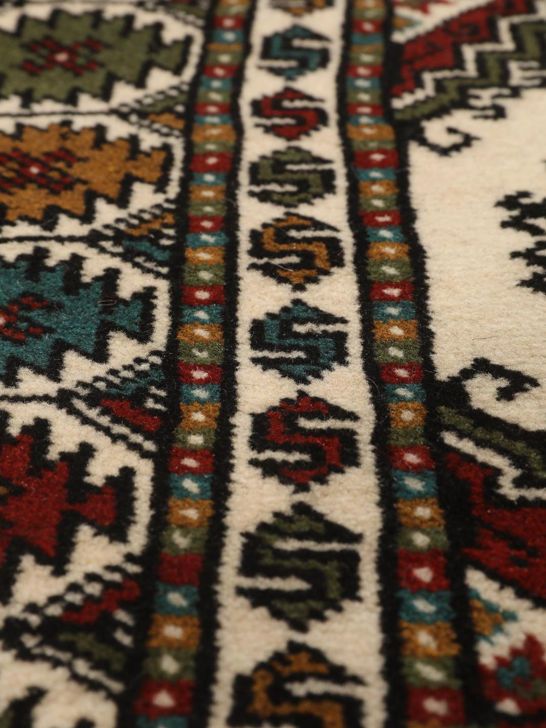Hand-knotted Turkaman rug from the Middle East in red and beige tones.