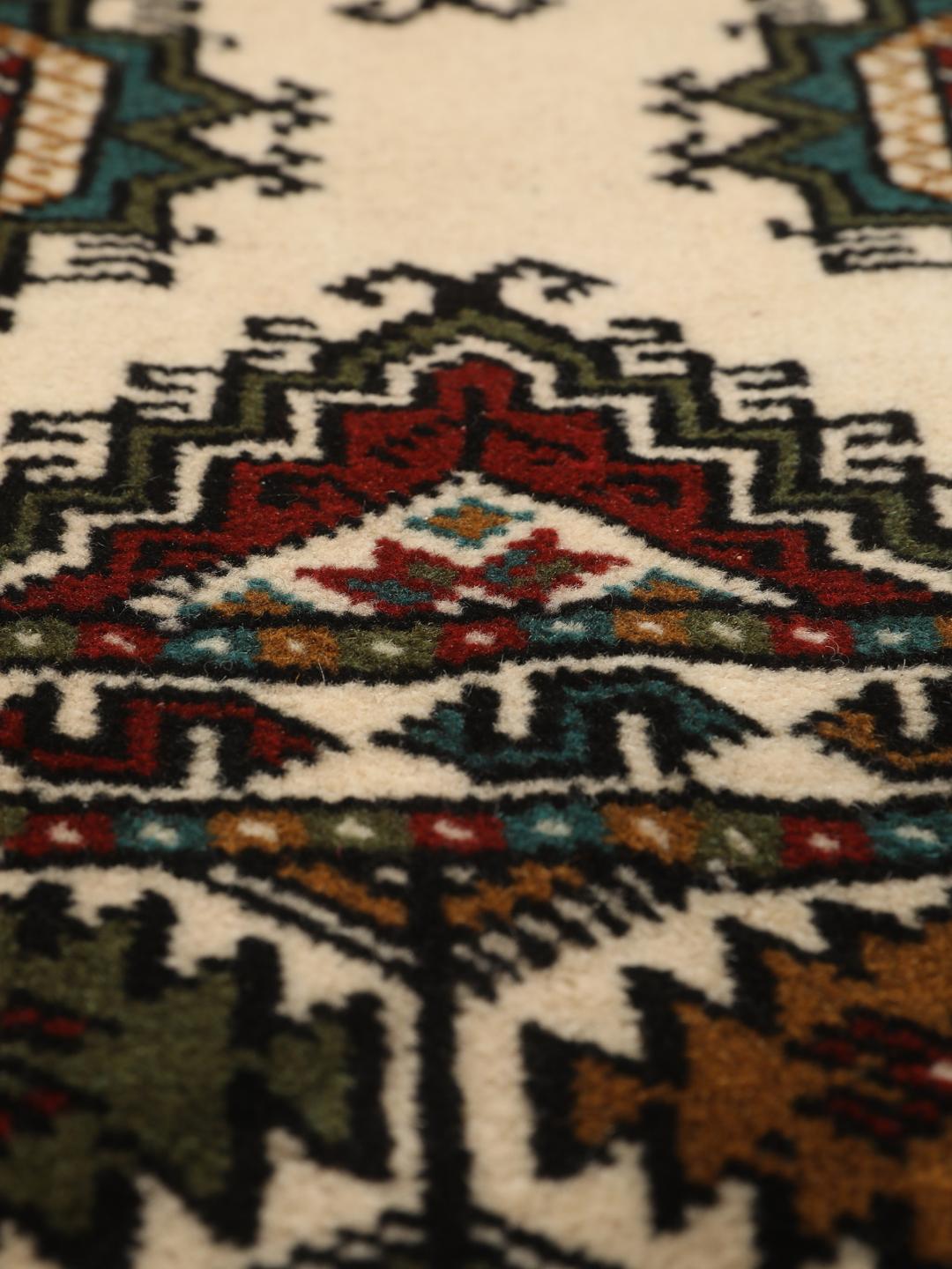 Hand-knotted Turkaman rug from the Middle East in red and beige tones.