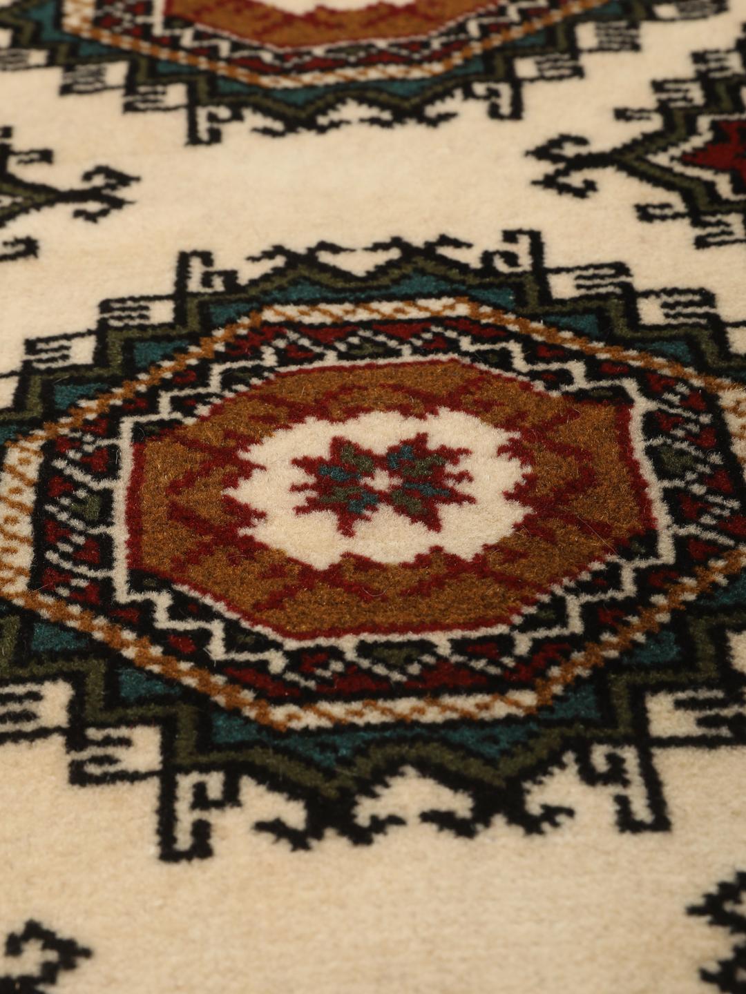 Hand-knotted Turkaman rug from the Middle East in red and beige tones.