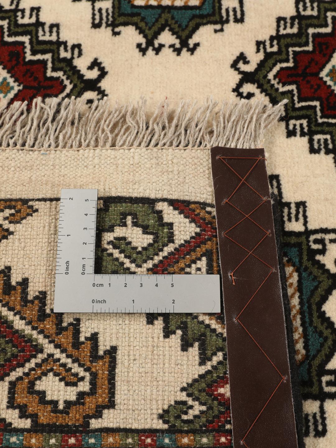 Hand-knotted Turkaman rug from the Middle East in red and beige tones.