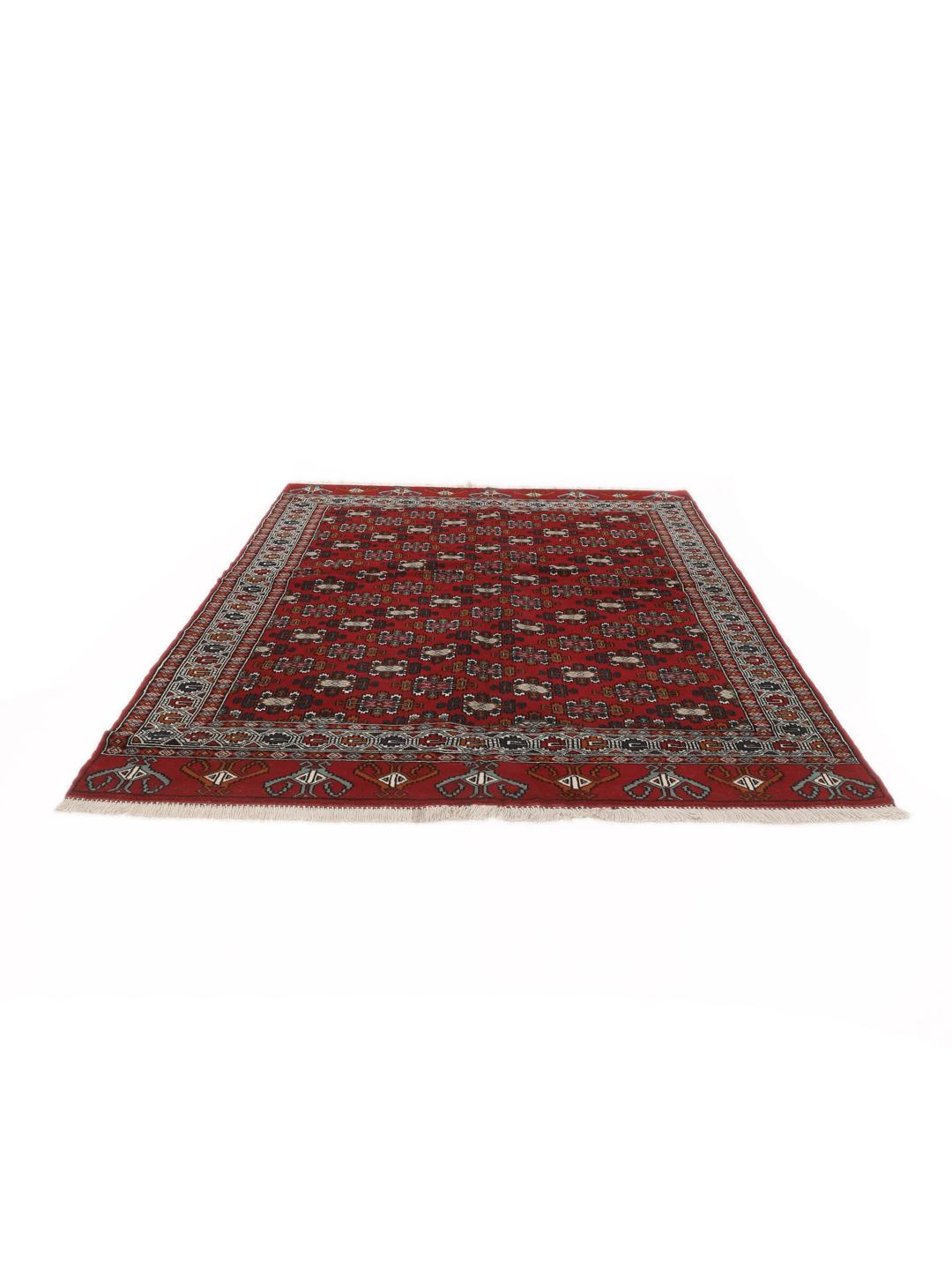 Hand-knotted Turkaman wool rug with a vibrant red field and tribal geometric patterns from the Middle East