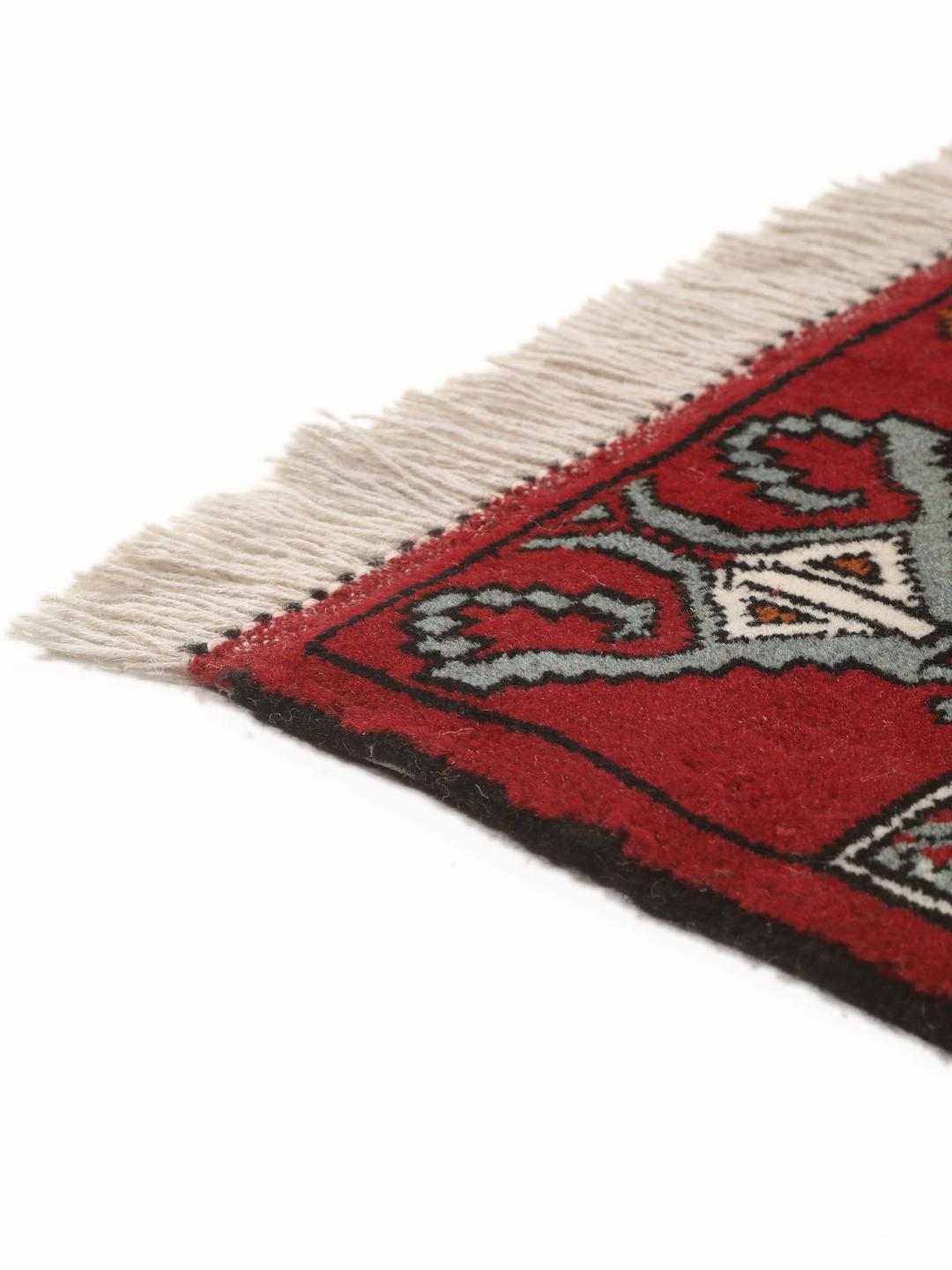 Hand-knotted Turkaman wool rug with a vibrant red field and tribal geometric patterns from the Middle East