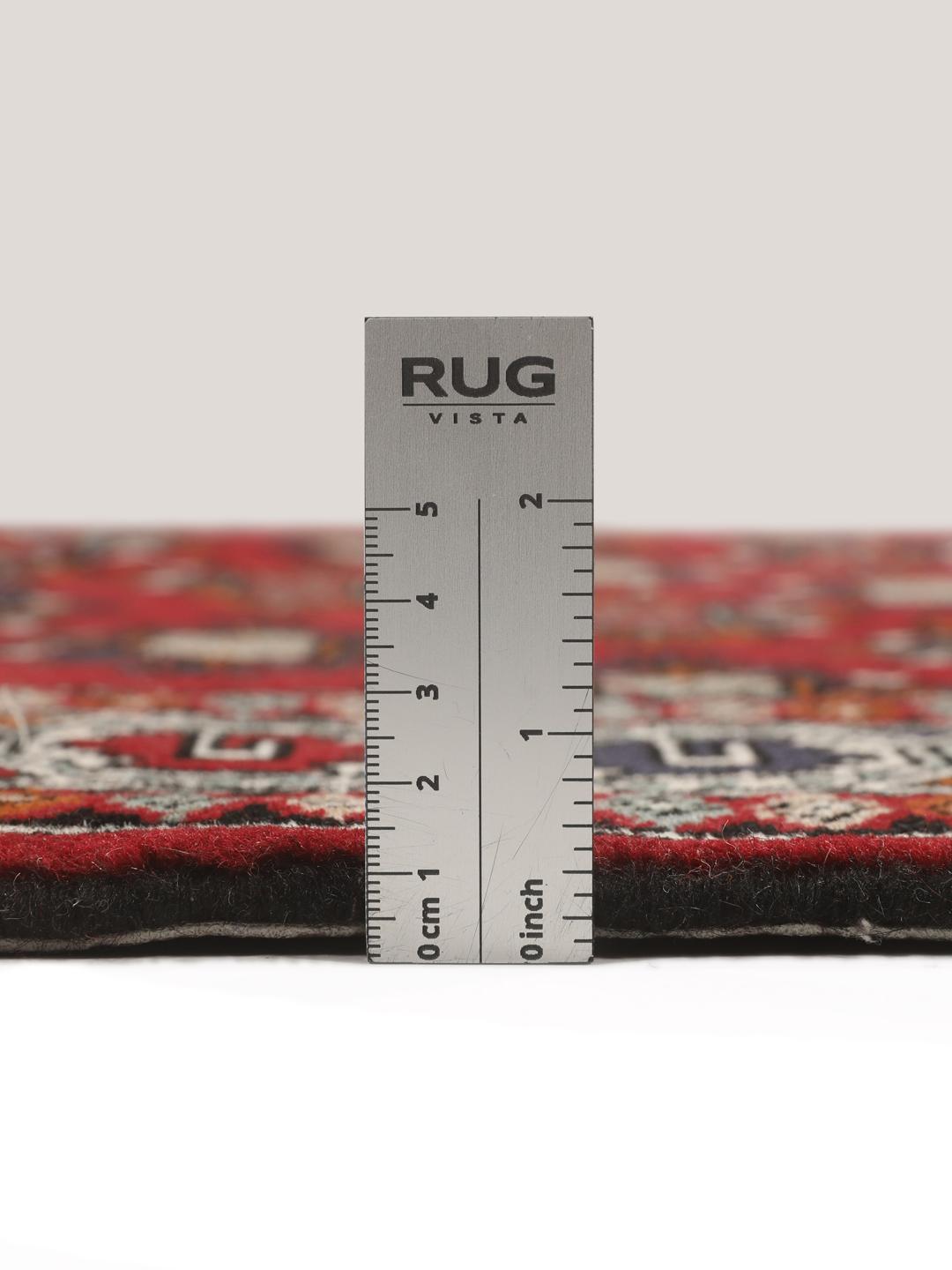 Hand-knotted Turkaman wool rug with a vibrant red field and tribal geometric patterns from the Middle East