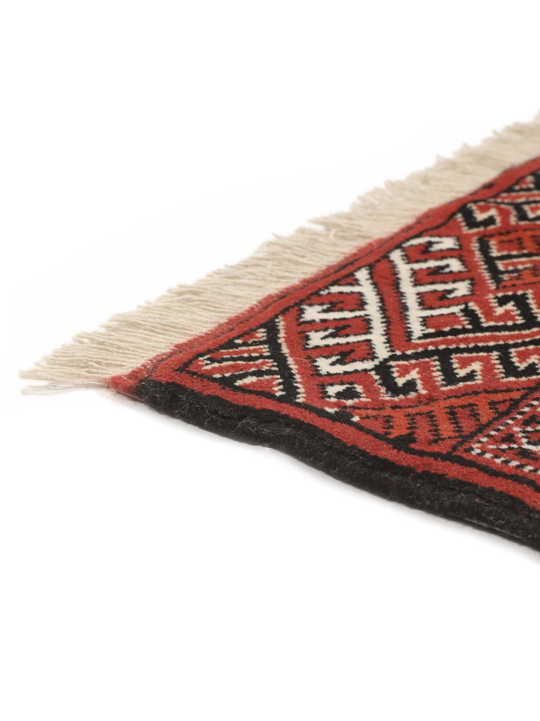 A hand-knotted red Turkaman runner with intricate geometric patterns.