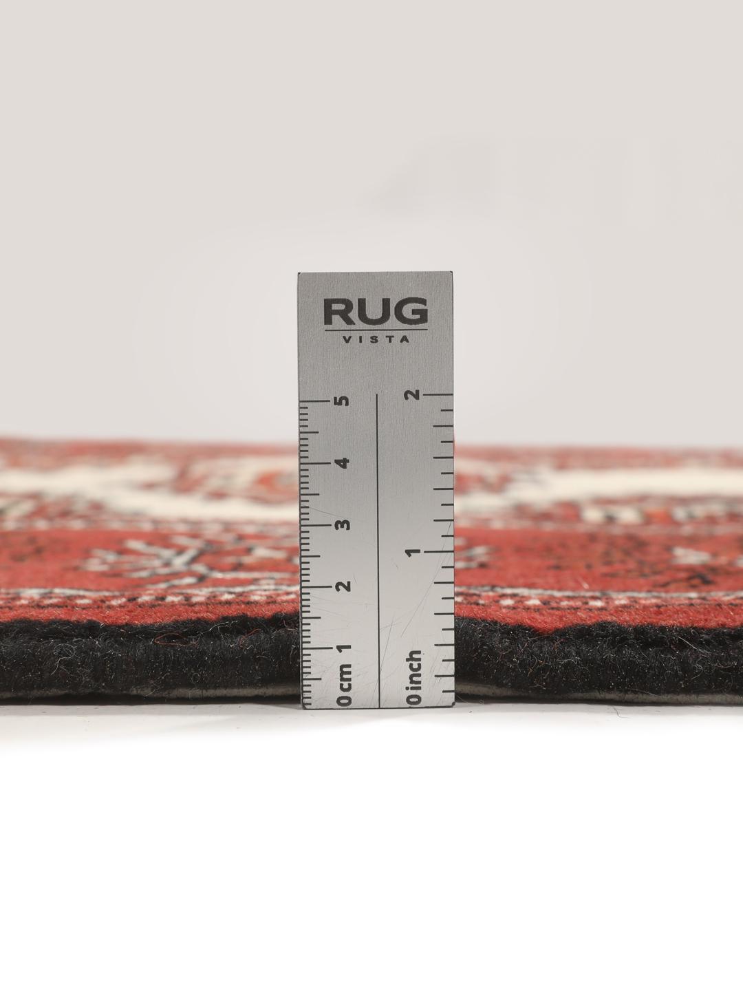A hand-knotted red Turkaman runner with intricate geometric patterns.