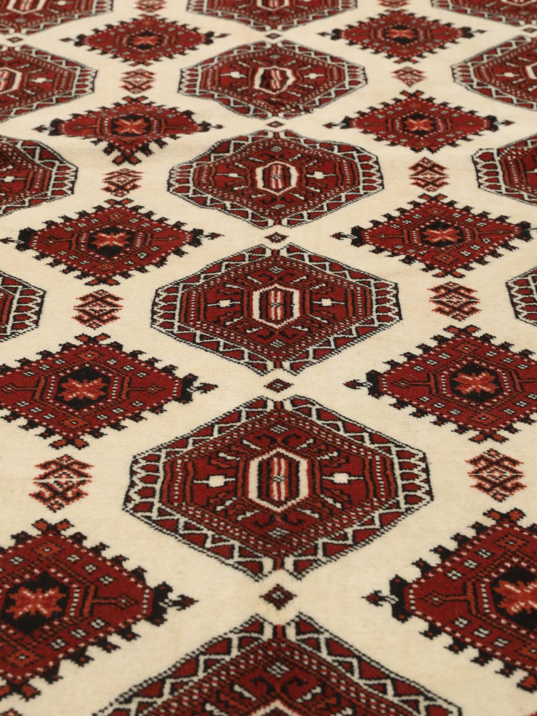 Hand-knotted Turkaman rug from the Middle East in shades of red and beige