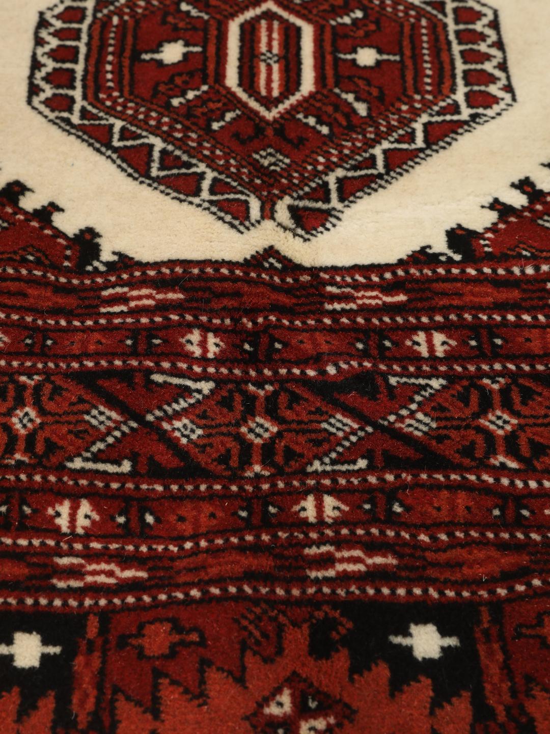Hand-knotted Turkaman rug from the Middle East in shades of red and beige