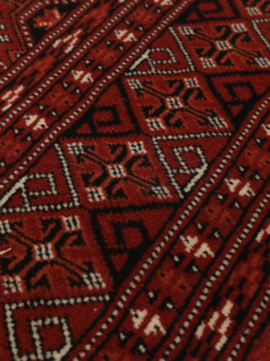 Hand-knotted Turkaman rug from the Middle East in shades of red and beige
