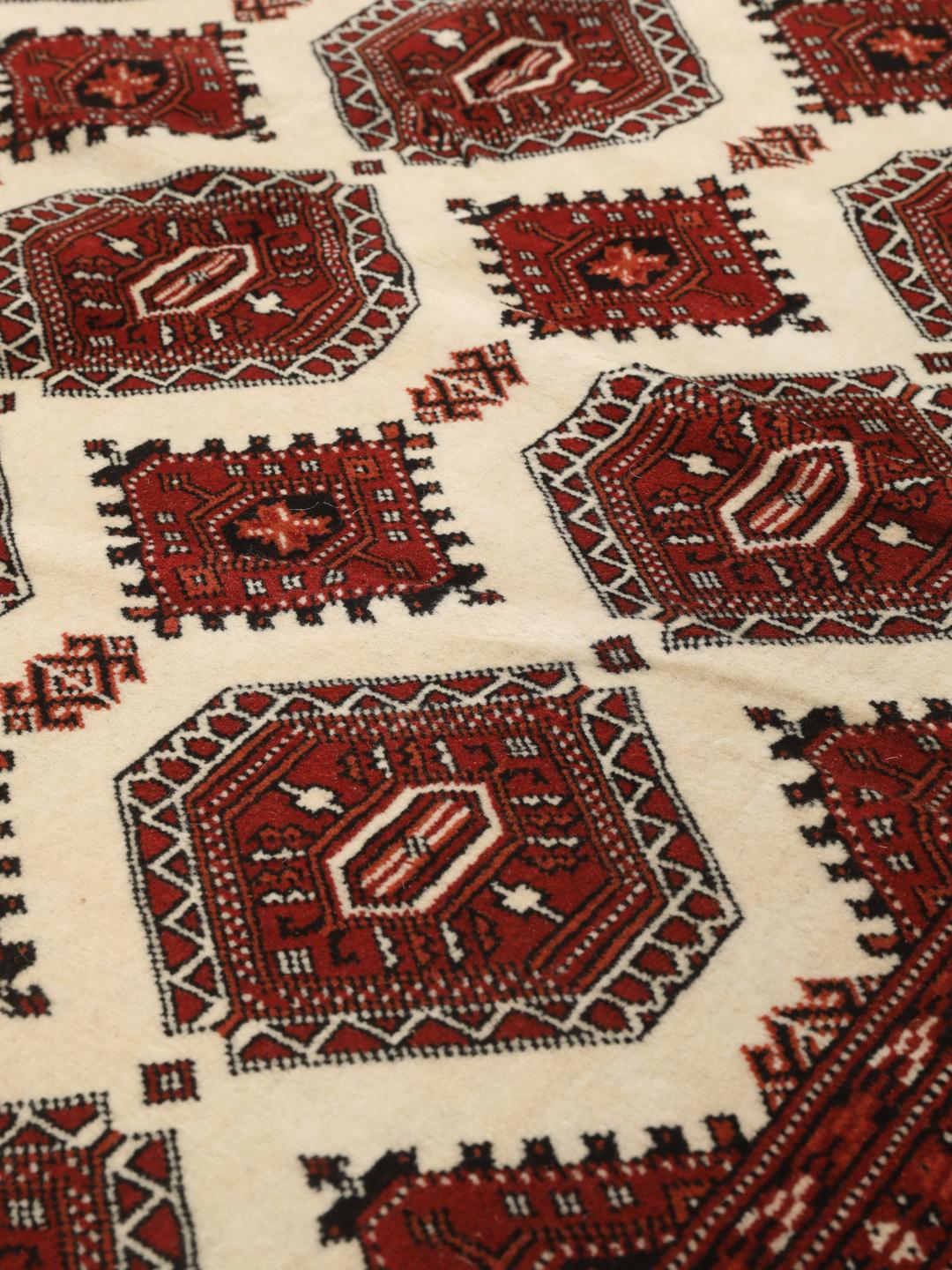 Hand-knotted Turkaman rug from the Middle East in shades of red and beige