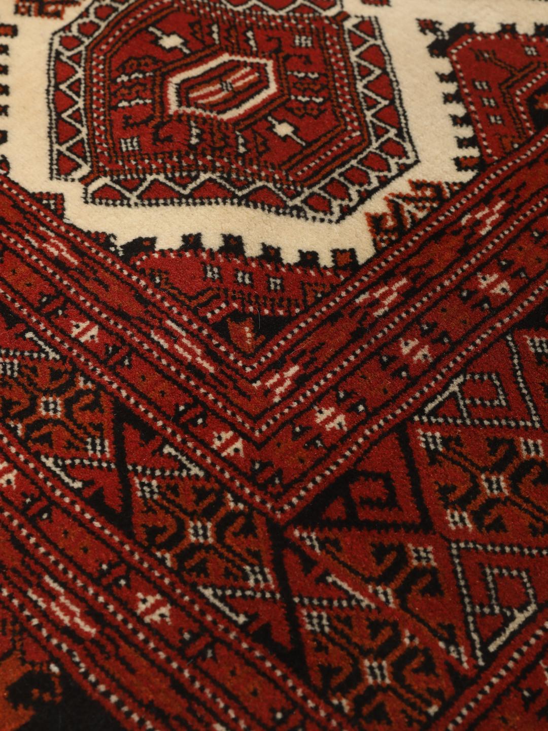 Hand-knotted Turkaman rug from the Middle East in deep red tones
