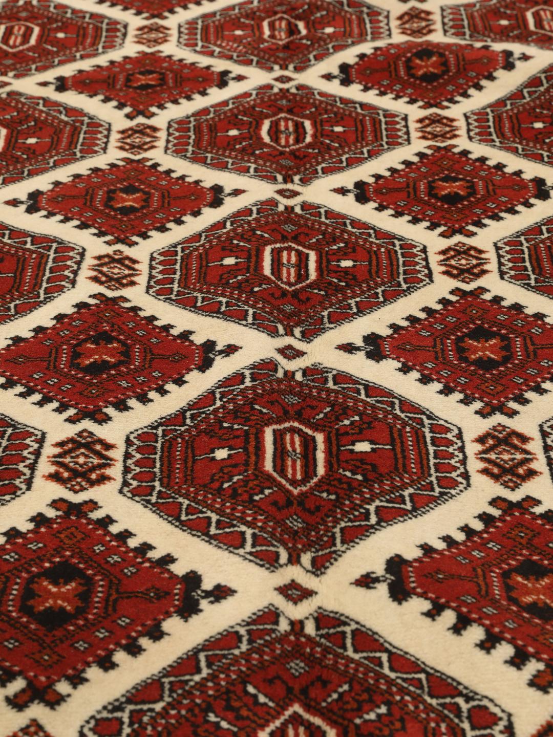 Hand-knotted Turkaman rug from the Middle East in deep red tones