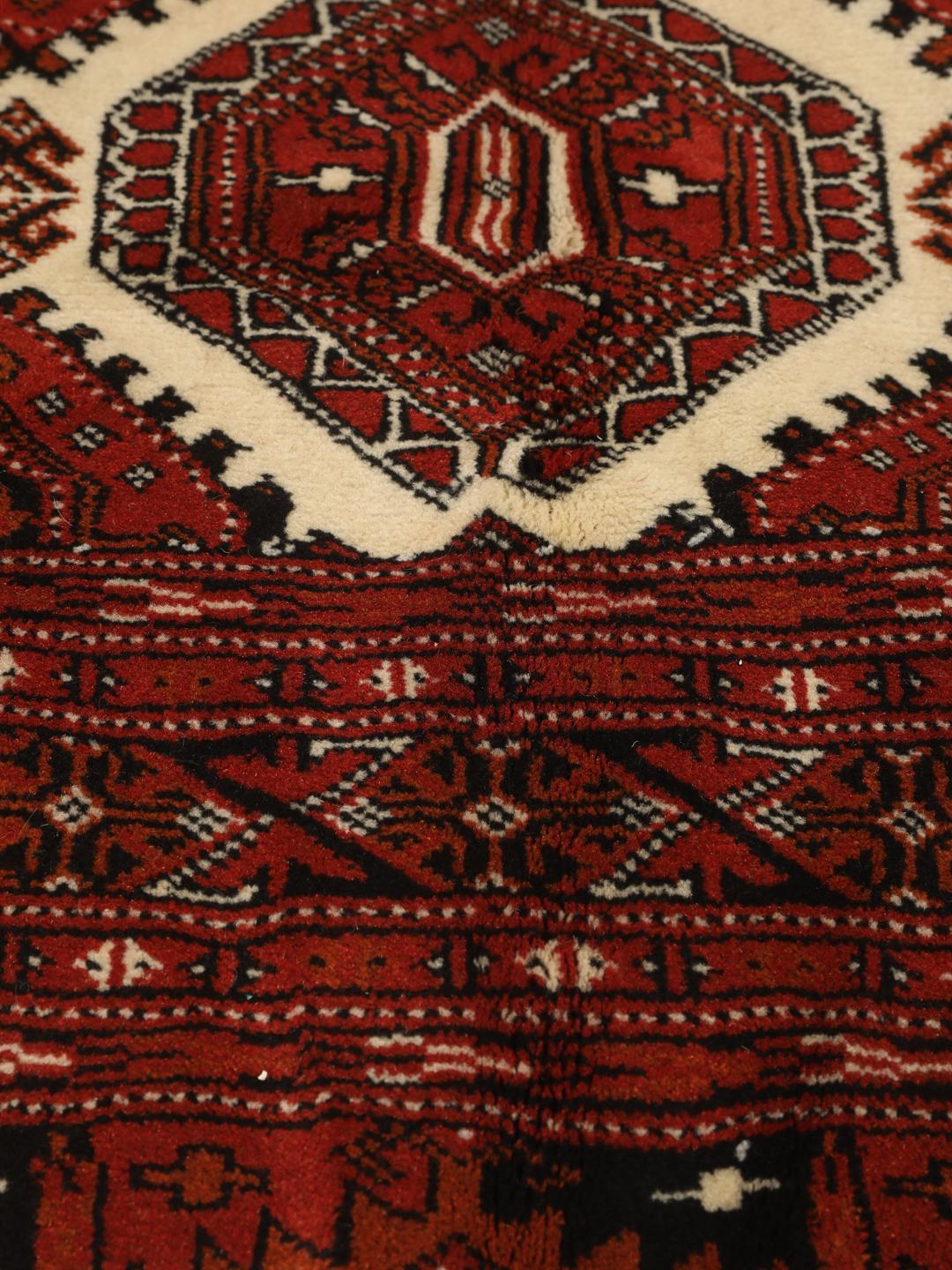 Hand-knotted Turkaman rug from the Middle East in deep red tones