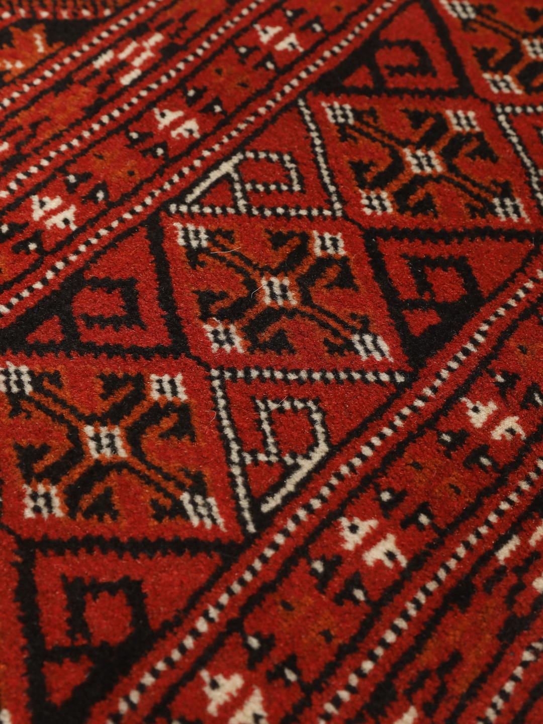 Hand-knotted Turkaman rug from the Middle East in deep red tones