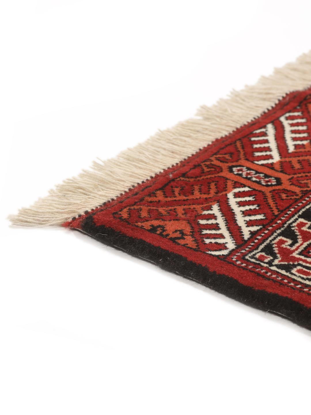 Hand-knotted Turkaman rug with a deep red field and geometric motifs