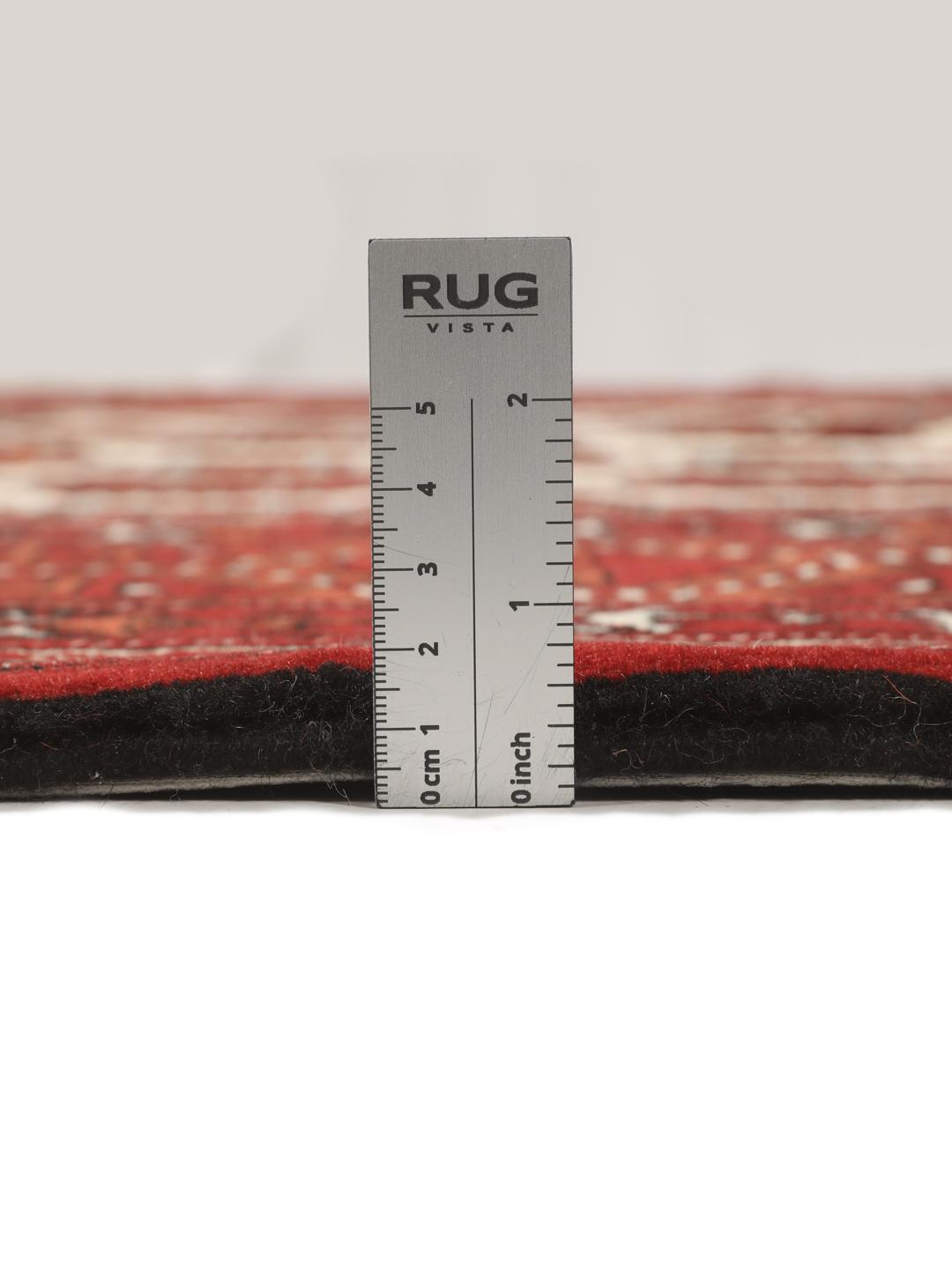 Hand-knotted Turkaman rug with a deep red field and geometric motifs