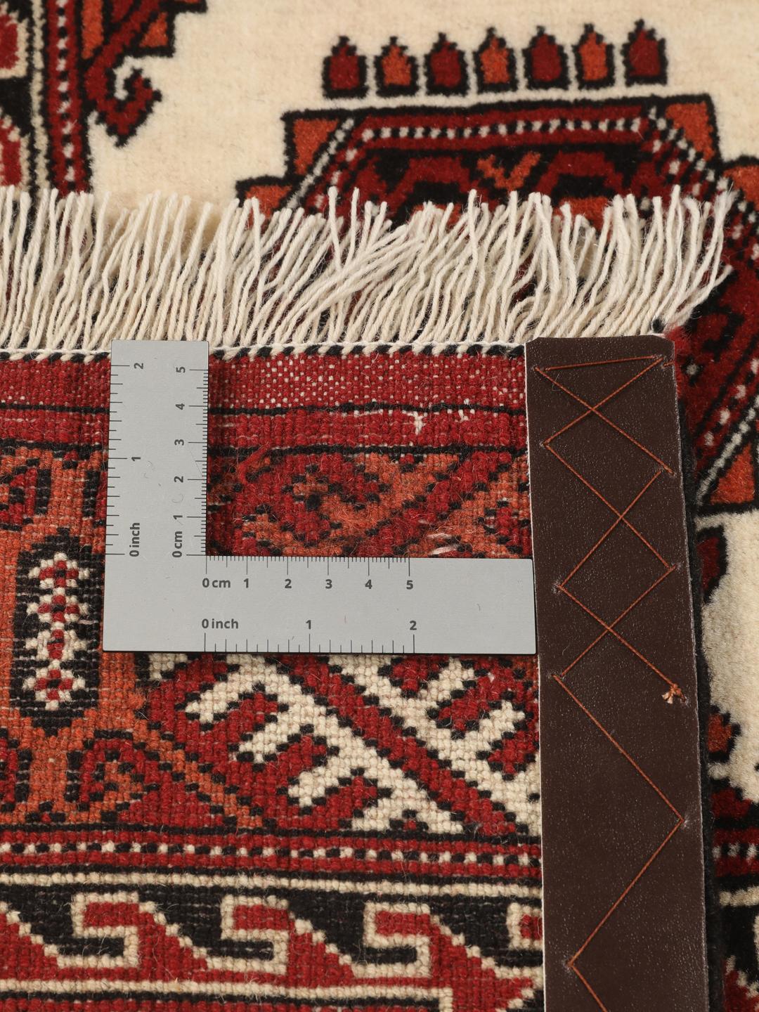 Hand-knotted Turkaman rug with a deep red field and geometric motifs