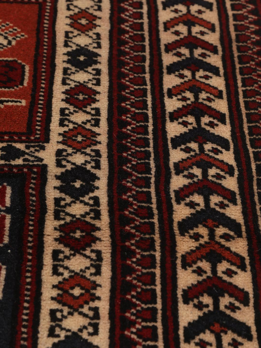 Hand-knotted Turkaman rug from the Middle East in red tones.