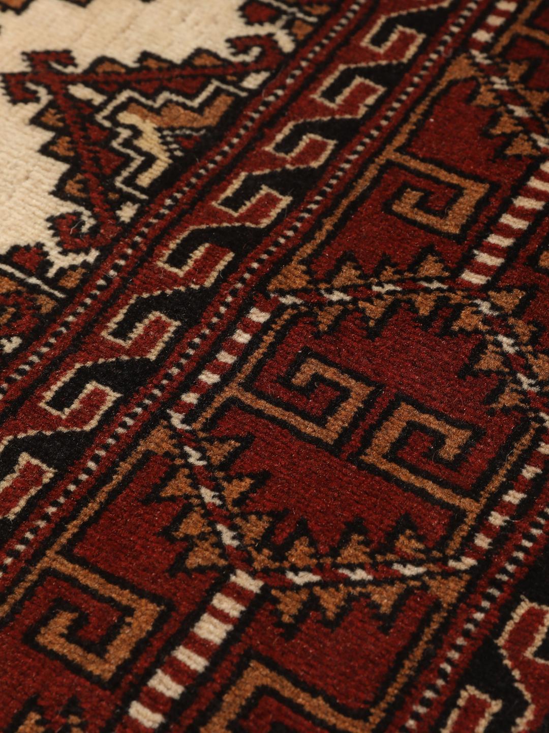 Hand-knotted Turkaman Wool rug with geometric patterns in red and beige from the Middle East.