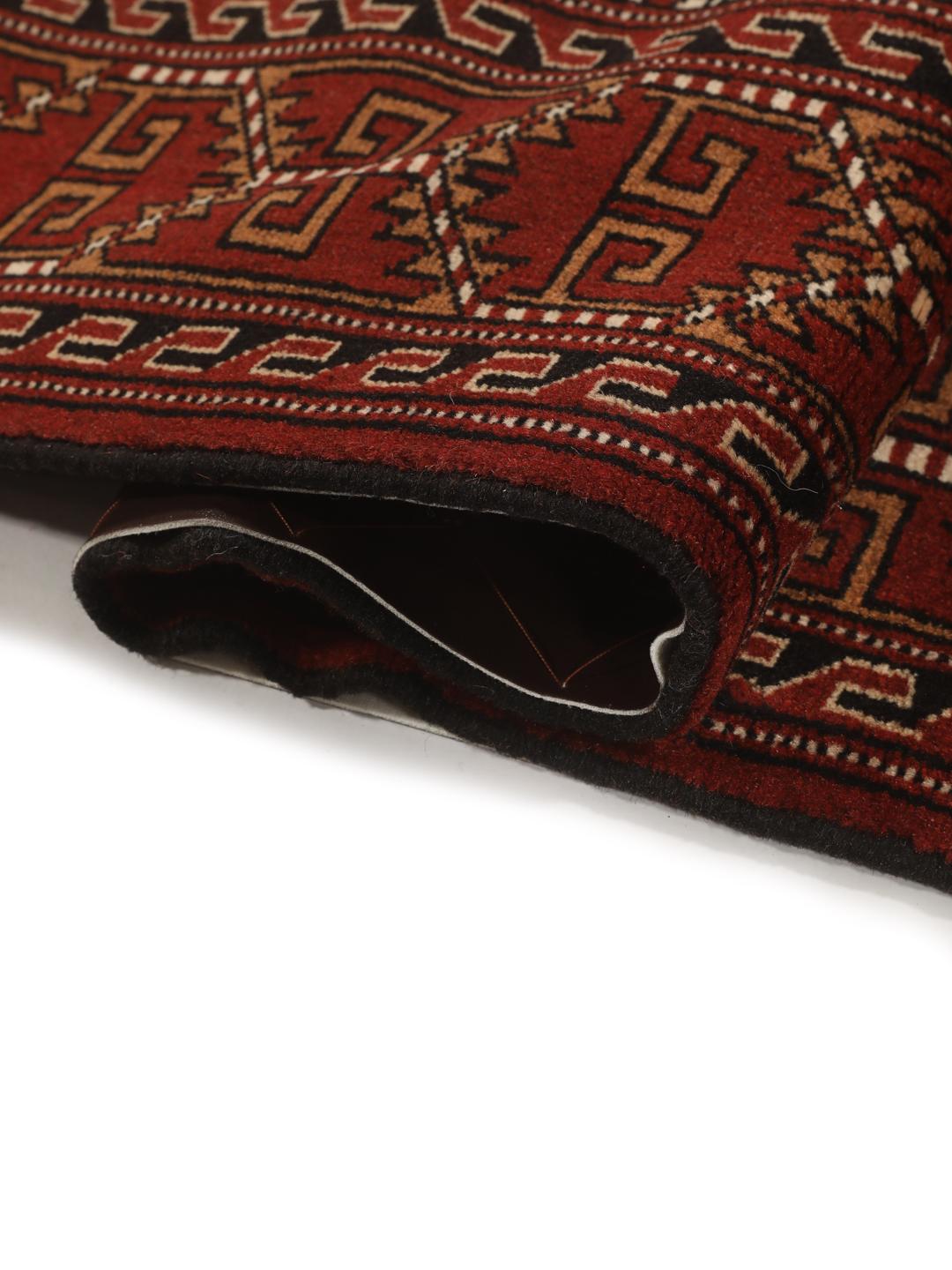 Hand-knotted Turkaman Wool rug with geometric patterns in red and beige from the Middle East.